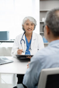 Pharmacist or doctor explaining medicine to a patient in a clinic setting, highlighting healthcare and patient support