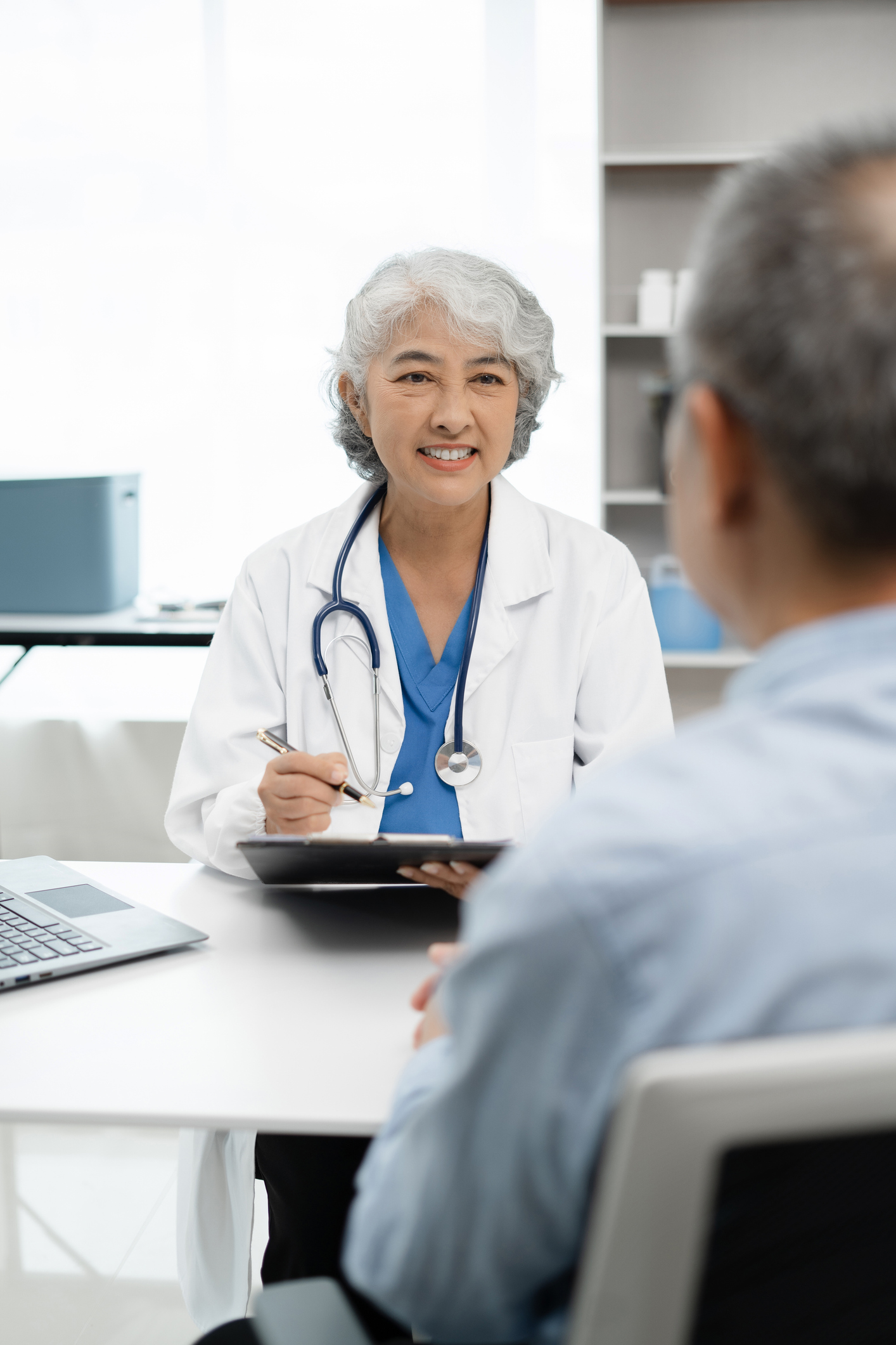 Pharmacist or doctor explaining medicine to a patient in a clinic setting, highlighting healthcare and patient support